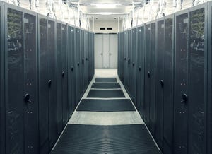 Photo of gray data center cabinets and hallway.